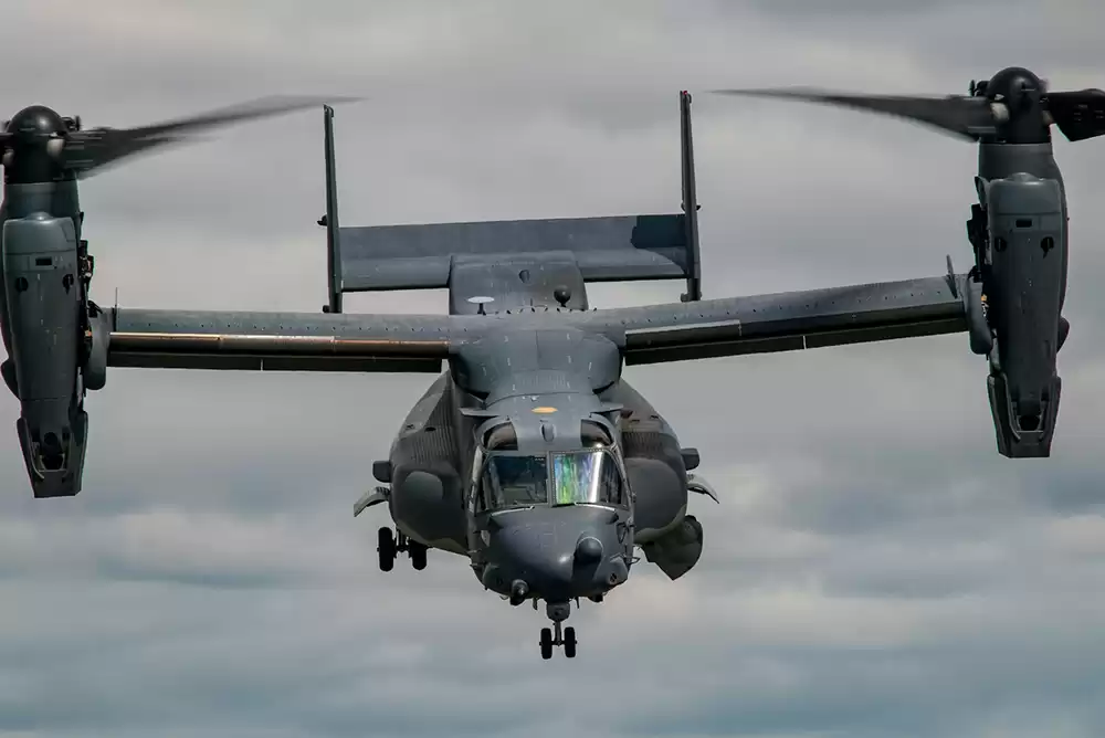 Black military helicopter hovering in the sky