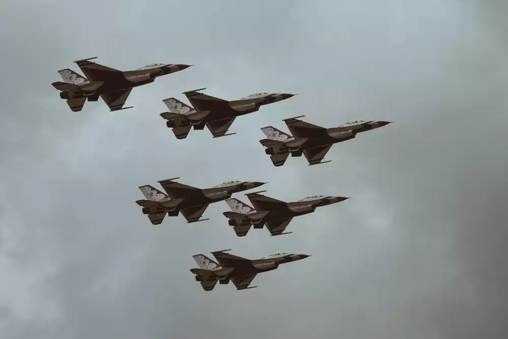 Six jet fighters performing at an air show