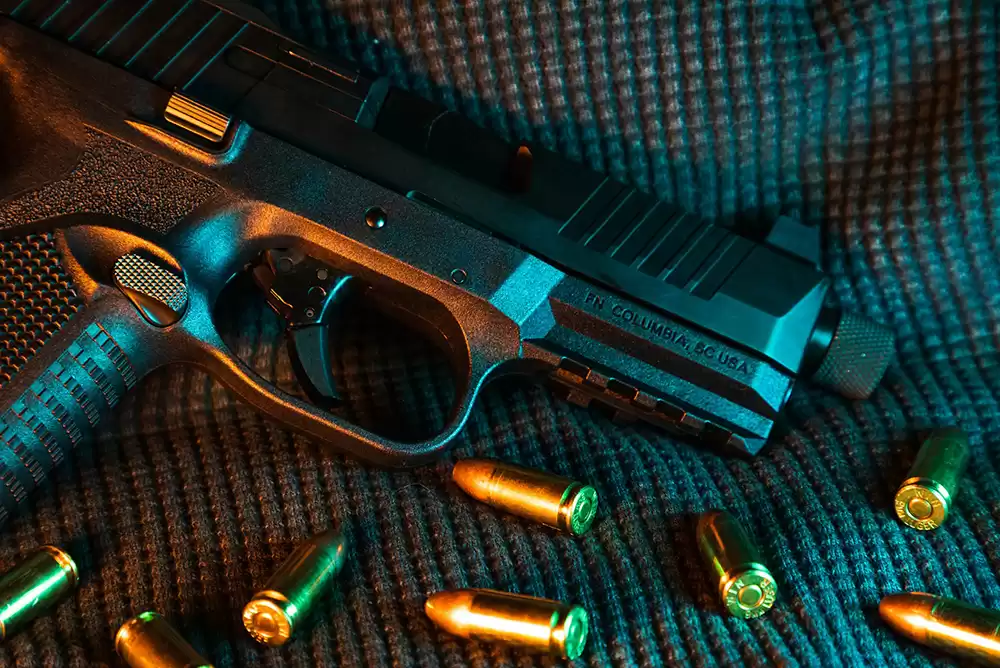 A semi-automatic pistol surrounded by bullets.